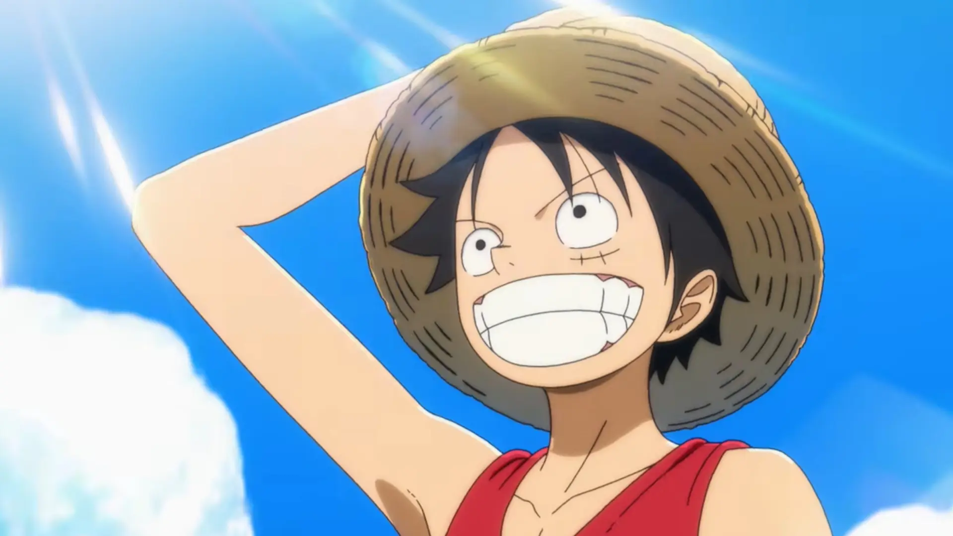 Luffy sonriendo bajo el sol con su sombrero de paja